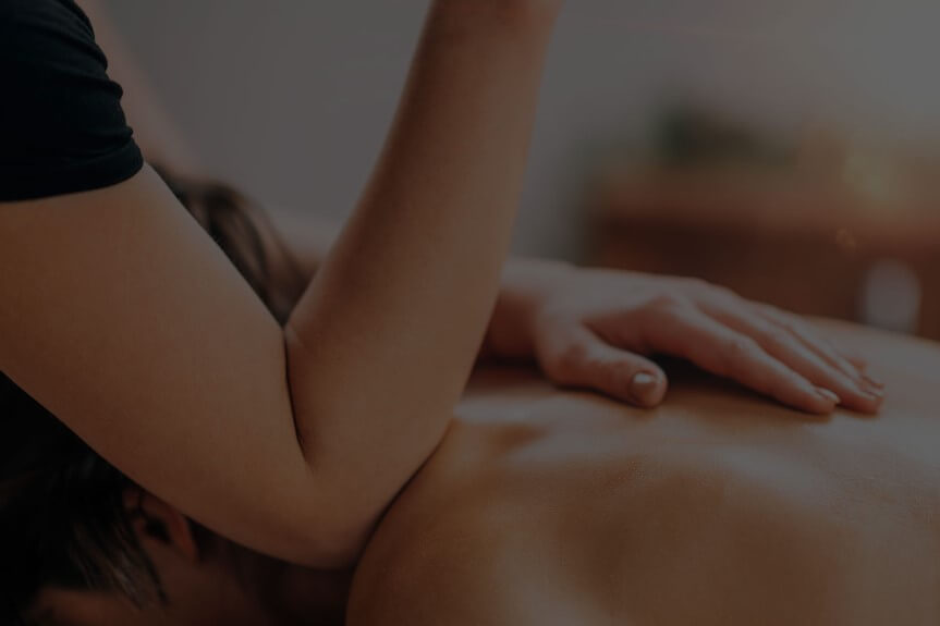 Person receiving a back massage from a therapist with their elbow.